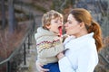 Mother and little son in park or forest, outdoors. Hugging and having fun together. Happy toddler boy and young mum, kid Royalty Free Stock Photo