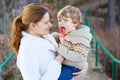 Mother and little son in park or forest, outdoors. Royalty Free Stock Photo