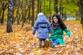 Mother with little son plays in autumn park Royalty Free Stock Photo