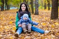 Mother with little son plays in autumn park Royalty Free Stock Photo