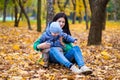 Mother with little son plays in autumn park Royalty Free Stock Photo