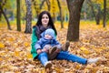 Mother with little son plays in autumn park Royalty Free Stock Photo