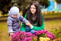 Mother with little son plays in autumn park Royalty Free Stock Photo