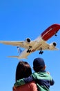 Mother and little two years old son enjoy their time watching large airplanes landing in Barcelona.