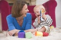 Mother in living room playing with baby Royalty Free Stock Photo