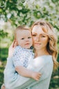 Mother with long curly red hair playing with her son in the park. Happy family enjoying relaxing and enjoying life in nature. Royalty Free Stock Photo