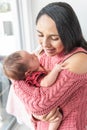 Mother looking at her baby tenderly as she carries her in her arms Royalty Free Stock Photo