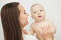 Mother looks at child with care love, baby on arms Royalty Free Stock Photo