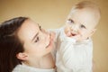 Mother looks at child with care love, baby on arms Royalty Free Stock Photo