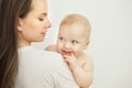 Mother looks at child with care love, baby on arms Royalty Free Stock Photo