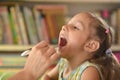 Mother looks throat of Sick girl