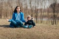 Mother in Lotus Pose Trying to Relax Outside