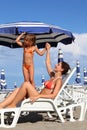 Mother lying on lounger. daughter standing near