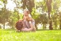 Mother lying on the mat holding her girl on the legs in the air at the park Royalty Free Stock Photo