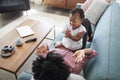 Mother Lying On Sofa At Home Playing Clapping Game With Baby Daughter Royalty Free Stock Photo