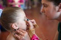 Mother makes a makeup for her daughter before the concert show Royalty Free Stock Photo