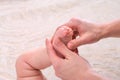 Mother makes massage foot for newborn baby