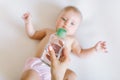 Mother makes massage for happy baby, apply oil on the hand, with white background Royalty Free Stock Photo