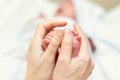 Mother making baby feet massage for newborn infant child. Mom massaging legs of small baby son.Children healthcare and happy Royalty Free Stock Photo