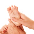 Mother making baby foot massage. Royalty Free Stock Photo