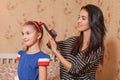 Mother making hairstyle to her daughter Royalty Free Stock Photo