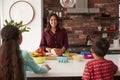 Mother Making School Lunches For Children In Kitchen At Home