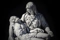 Mother Mary with the dead Jesus in her arms. Dark background. Special tone effect concept of death Royalty Free Stock Photo