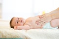 Mother massaging crying baby with colic Royalty Free Stock Photo