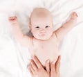 Mother massaging baby Royalty Free Stock Photo