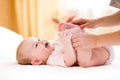 Mother massaging or doing gymnastics baby girl Royalty Free Stock Photo