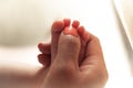 Mother massaging her baby feet Royalty Free Stock Photo