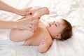 Mother massaging her baby girl Royalty Free Stock Photo