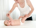 Mother massaging her infant baby Royalty Free Stock Photo