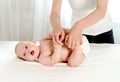 Mother massaging her infant baby Royalty Free Stock Photo