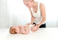 Mother massaging her infant baby Royalty Free Stock Photo