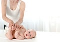 Mother massaging her infant baby Royalty Free Stock Photo