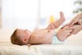 Mother or masseuer massaging baby in nursery room Royalty Free Stock Photo