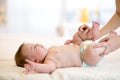 Mother or masseuer massaging newborn baby Royalty Free Stock Photo