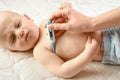 Mother measures the temperature of a ill child. maternal care for baby