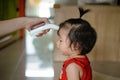 Mother measuring temperature cute baby girl at home. Royalty Free Stock Photo