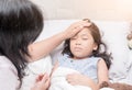 Mother measuring temperature of her ill kid by hand.