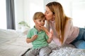 Mother measuring temperature of her ill kid. Sick child with high fever, mother holding thermometer. Royalty Free Stock Photo