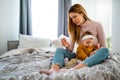 Mother measuring temperature of her ill kid. Sick child with high fever, mother holding thermometer. Royalty Free Stock Photo