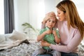 Mother measuring temperature of her ill kid. Sick child with high fever, mother holding thermometer. Royalty Free Stock Photo