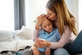 Mother measuring temperature of her ill kid. Sick child with high fever, mother holding thermometer. Royalty Free Stock Photo