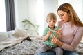 Mother measuring temperature of her ill kid. Sick child with high fever, mother holding thermometer. Royalty Free Stock Photo