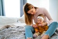 Mother measuring temperature of her ill kid. Sick child with high fever, mother holding thermometer. Royalty Free Stock Photo