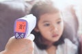 Mother measuring temperature her sick asian little child girl Royalty Free Stock Photo