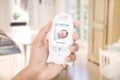 Mother mnitoring sleeping baby through baby monitor Royalty Free Stock Photo