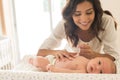 Mother moisturizing baby Royalty Free Stock Photo